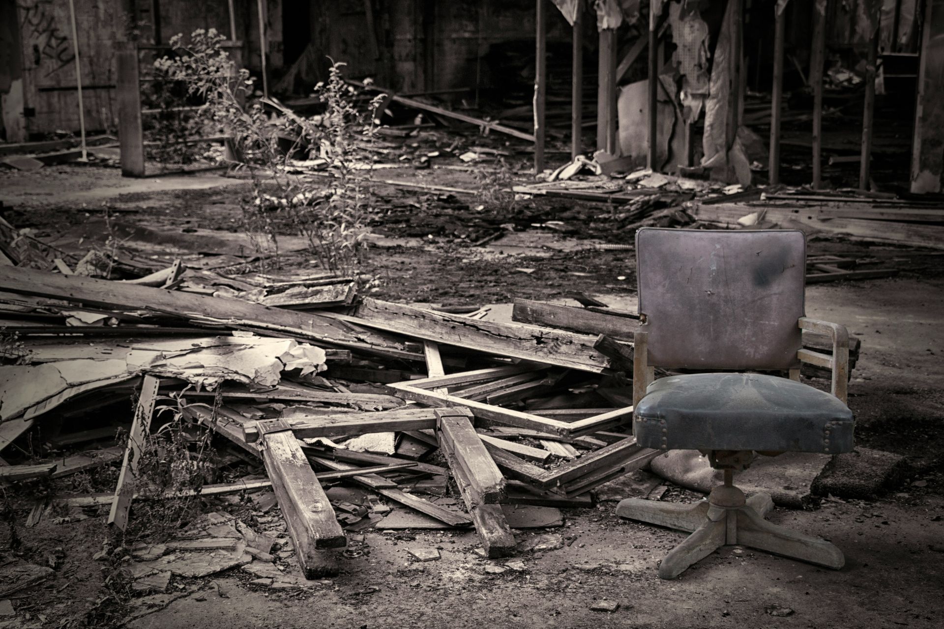 An old chair sits in a destroyed landscape